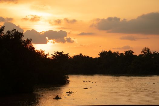 A stunning sunset with storm in the distance on the Mekong River near Can Tho in Vietnam