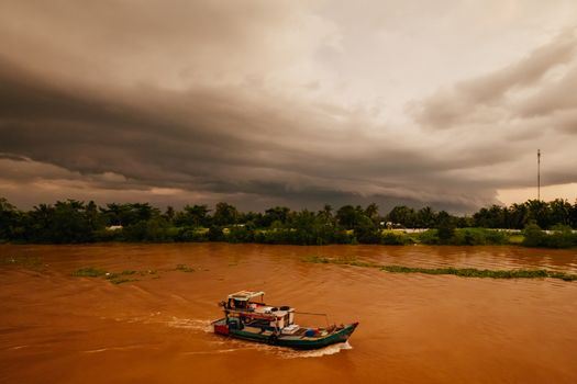 A stunning sunset with storm in the distance on the Mekong River near Can Tho in Vietnam