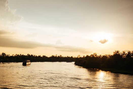 A stunning sunset with storm in the distance on the Mekong River near Can Tho in Vietnam