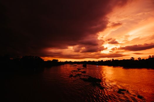 A stunning sunset with storm in the distance on the Mekong River near Can Tho in Vietnam