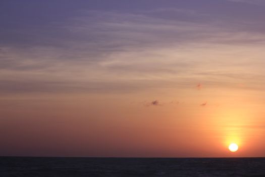The morning sunrise over the horizon in the sea