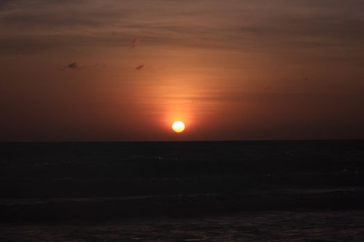 The morning sunrise over the horizon in the sea