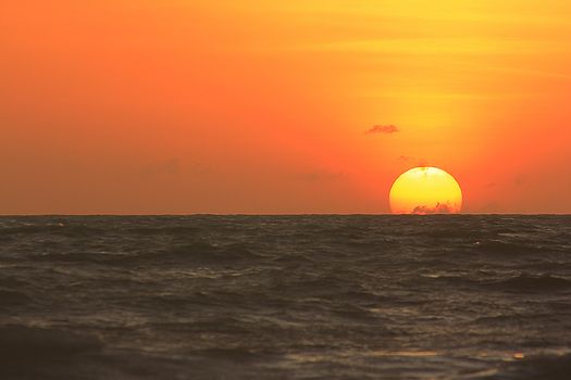 The morning sunrise over the horizon in the sea