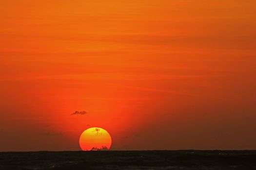 The morning sunrise over the horizon in the sea