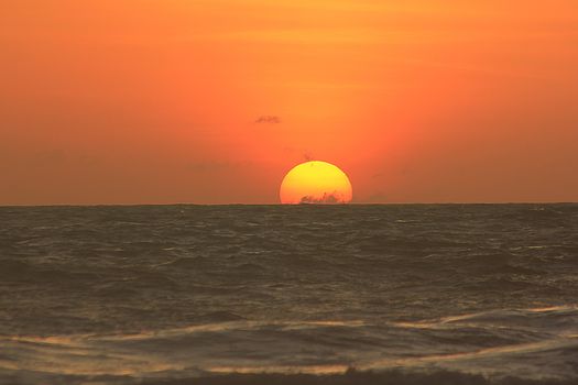 The morning sunrise over the horizon in the sea