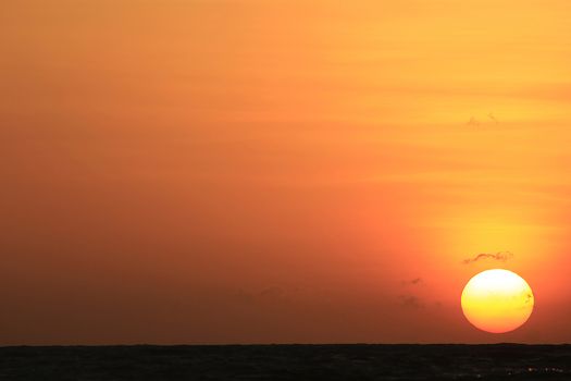 The morning sunrise over the horizon in the sea