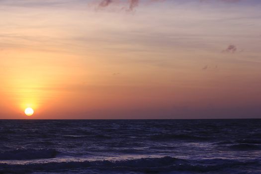 The morning sunrise over the horizon in the sea