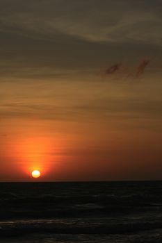 The morning sunrise over the horizon in the sea