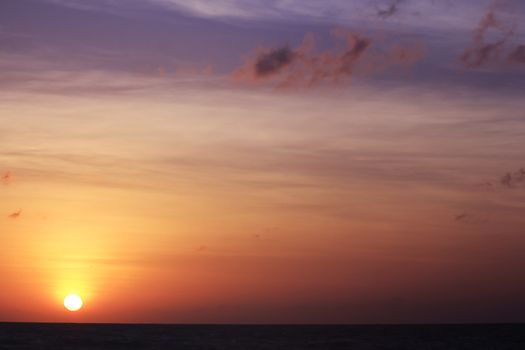 The morning sunrise over the horizon in the sea