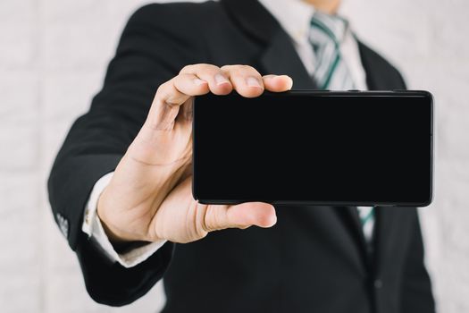 A business man with a show screen smartphone