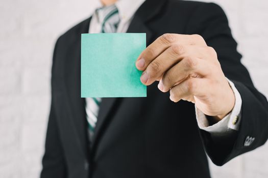 Business man holding card paper post-it notes