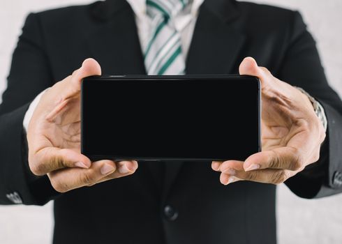 A business man with a show screen smartphone