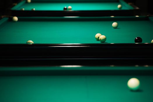 Sports game of billiards on a green cloth. Billiards white billiard balls close up