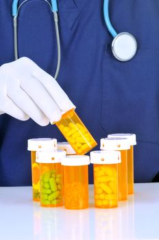 Doctor choosing prescription bottle from many others