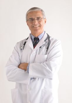 Middle Aged Doctor in Lab Coat with Arms Folded vertical format over gray background