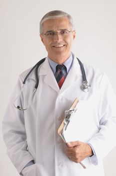 Smiling Middle Aged  Doctor in Labcoat with Stethoscope and Clip Board