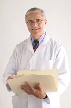 Middle Aged Doctor in Lab Coat Holding Folder with Patients Chart vertical format over gray background