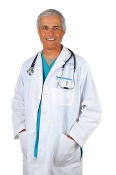 Smiling Middle Aged Doctor Standing with his hands in the pockets of a Lab Coat. Man is wearing green surgical scrubs with a stethoscope around his neck. Vertical isolated on white.
