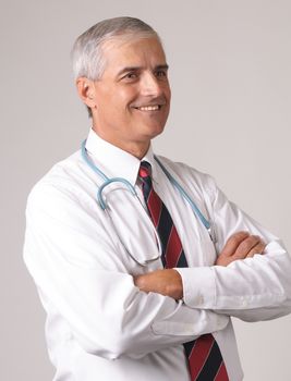 Profile Portrait of Smiling Middle Aged  Doctor with Stethoscope and arms crossed