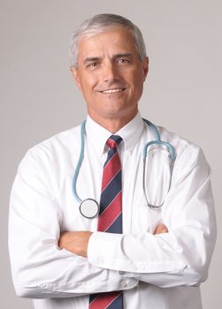 Portrait of Smiling Middle Aged  Doctor with Stethoscope and arms crossed