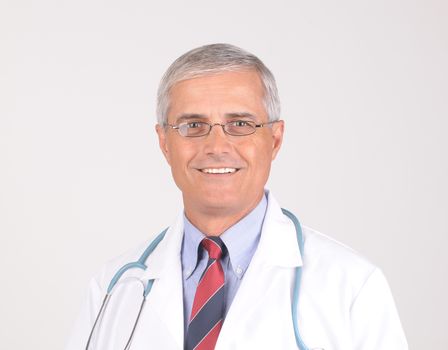 Portrait of a Middle Aged  Male Doctor in Lab Coat with Stethoscope - gray background