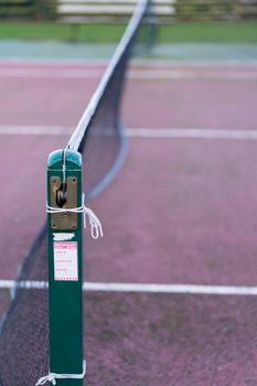 A close up of an outdoor tennis court net in the UK