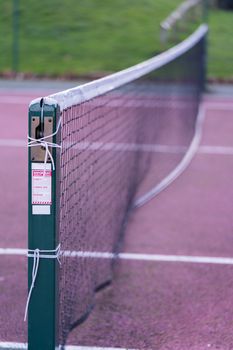 A close up of an outdoor tennis court net in the UK