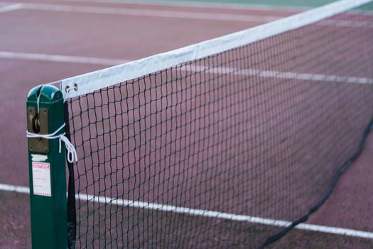 A close up of an outdoor tennis court net in the UK