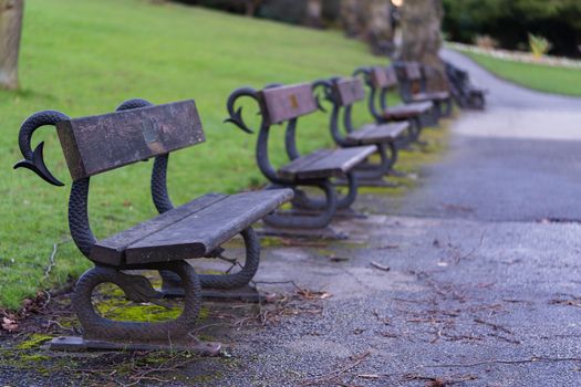 Traditional wooden park benches in a local park in England