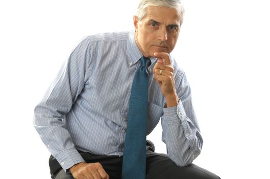 Seated serious Businessman resting his chin on his hand isolated on white background