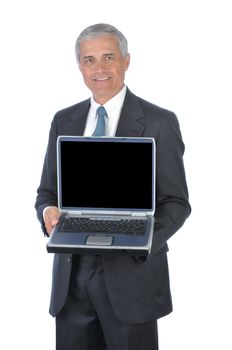 Smiling Businessman in dark suit standing with laptop computer open and facing the camera isolated on white