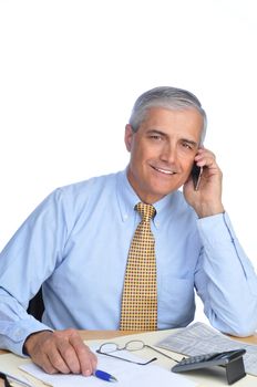 Middle Aged Businessman Sitting at Desk Talking on Cell Phone isolated on white.