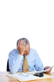 Businessman Reading Newspaper at His Desk with head resting in hand isolated on white