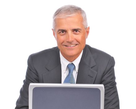 Mature Businessman seated looking over top of laptop isolated on white