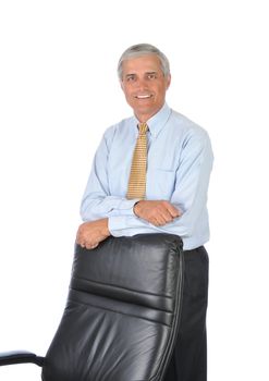 Middle Aged Businessman Standing and Leaning on Back of His Chair isolated on white