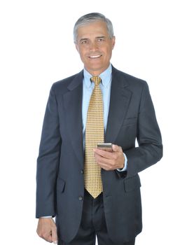 Smiling Businessman in dark suit standing and holding an electronic device isolated on white