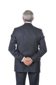 Standing Middle Aged Businessman with His Hands Behind Back isolated on white