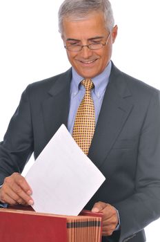 Smiling Businessman Putting Papers in File Box isolated on white