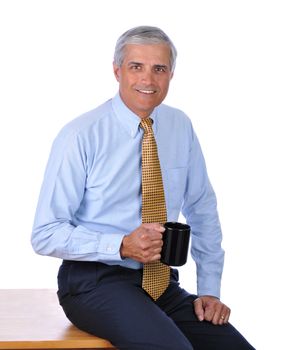 Businessman Sitting on Corner of His Desk With Coffee Mug isolated on white