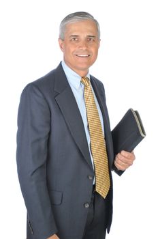 Middle aged businessman holding notebook in one hand. Man is standing and smiling. Vertical format isolated on white.
