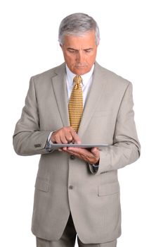 Middle aged businessman looking down at the tablet computer in his hands. Vertical format over a white background.