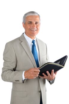 Portrait of a middle aged businessman over a white background. Man is holding an open notebook in vertical format.