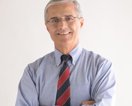 Portrait of a Middle Aged Businessman with Glasses over light gray background