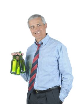 Middle aged businessman with tie undone holding two beers after a hard days work isolated over white