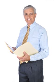 Middle aged businessman standing and holding a manila file folder. Vertical format isolated on white background.
