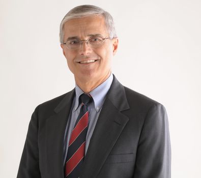 Portrait of a Middle Aged Businessman with Glasses over light gray background