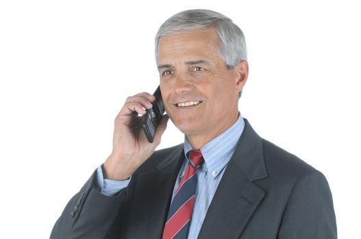 Close up of a smiling middle aged businessman talking on his cell phone isolated over white