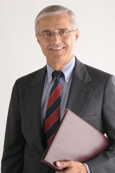 Middle Aged Businessman with Leather Folder under his arm over light gray background vertical format