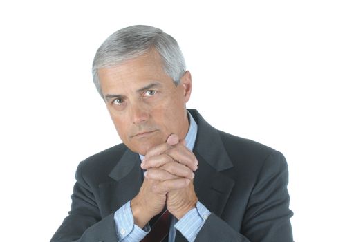 Portrait of a Serious Middle Aged Businessman with hand clasped in front of chin isolated over white