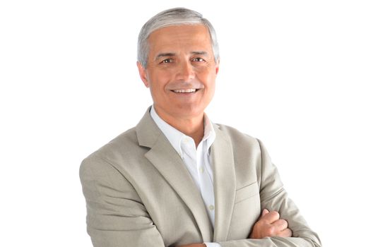 Portrait of a middle aged businessman with his arms folded over a white background. Man is smiling wearing a white shirt and sport coat.